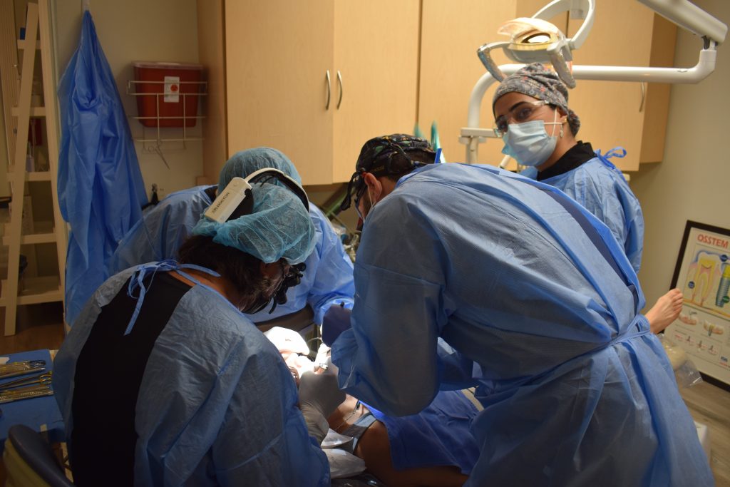 group of doctors doing a dental implant surgery 