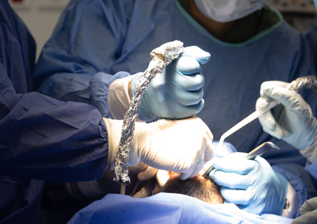 doctors in RWC surgery doing dental implant with live patient course