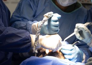doctors in RWC surgery doing dental implant with live patient course